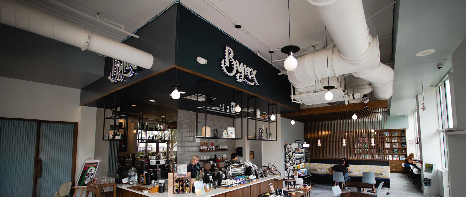 Hand-lettered Bynx logo over a photo of the coffee shop interior