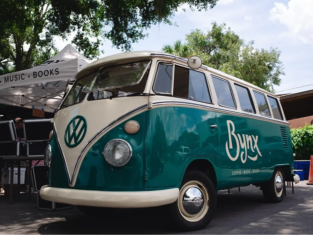 The Bynx logo on the side of a vintage teal Volkswagen van