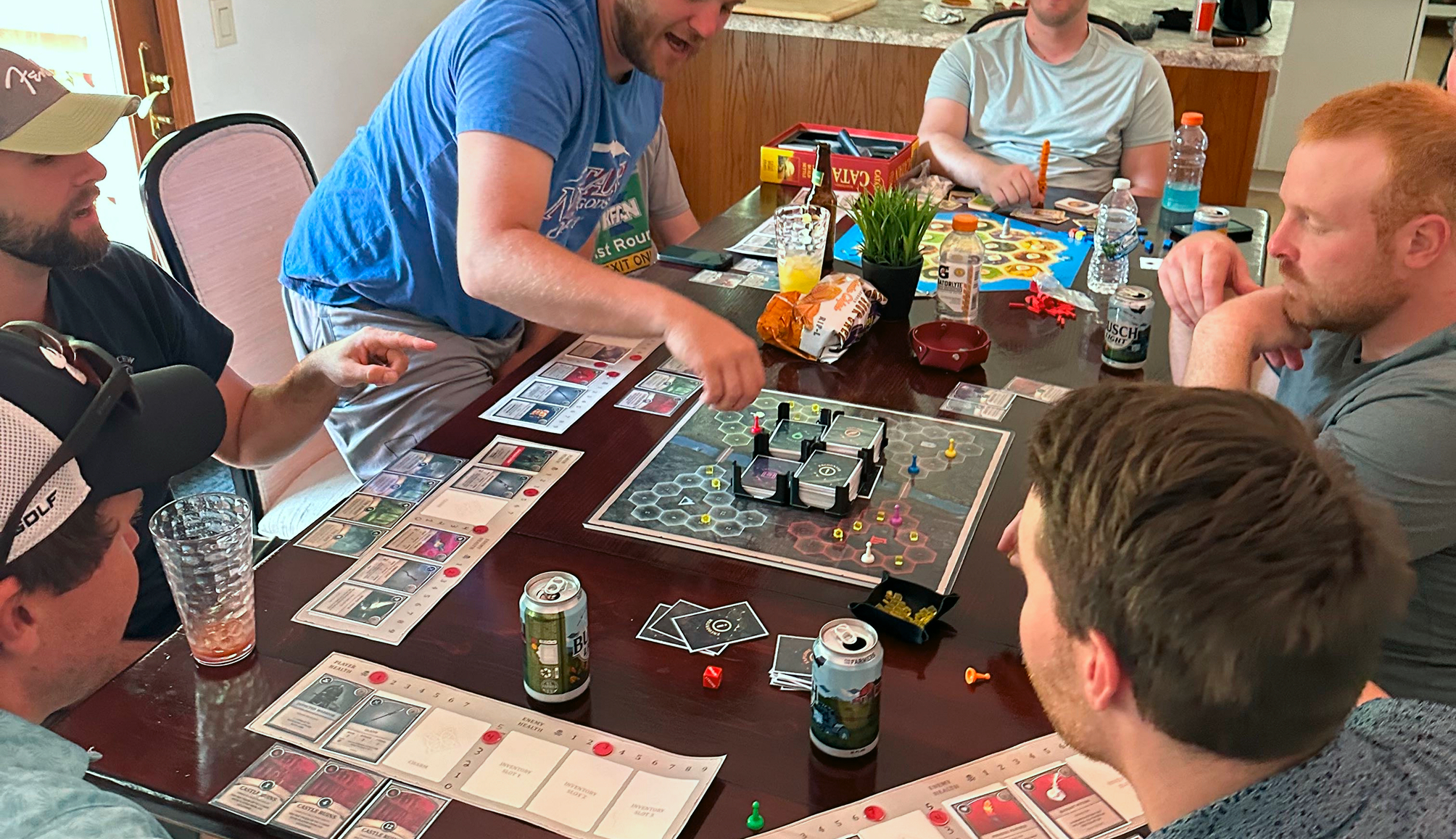 gamers sitting around a table engaged in strategy
